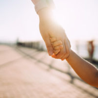 getty_5222_childholdinghand