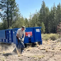 blm_park_ranger_charles_lindberg_heaves_a_load_into_the_dumpster