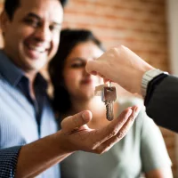 cheerful-couple-with-keys-to-their-new-home