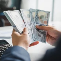 closeup-hands-businessman-banker-counting-money-banknote-dollars-bank-financial-and-investment-concept