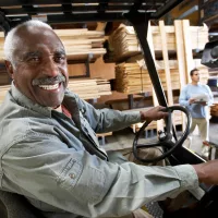 portrait-of-a-happy-senior-male-worker-driving-forktruck-2