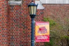 "2022 NAIA Men's Basketball National Champions" banner hangs from lamp post at Louise C. Thomas Hall at Loyola University