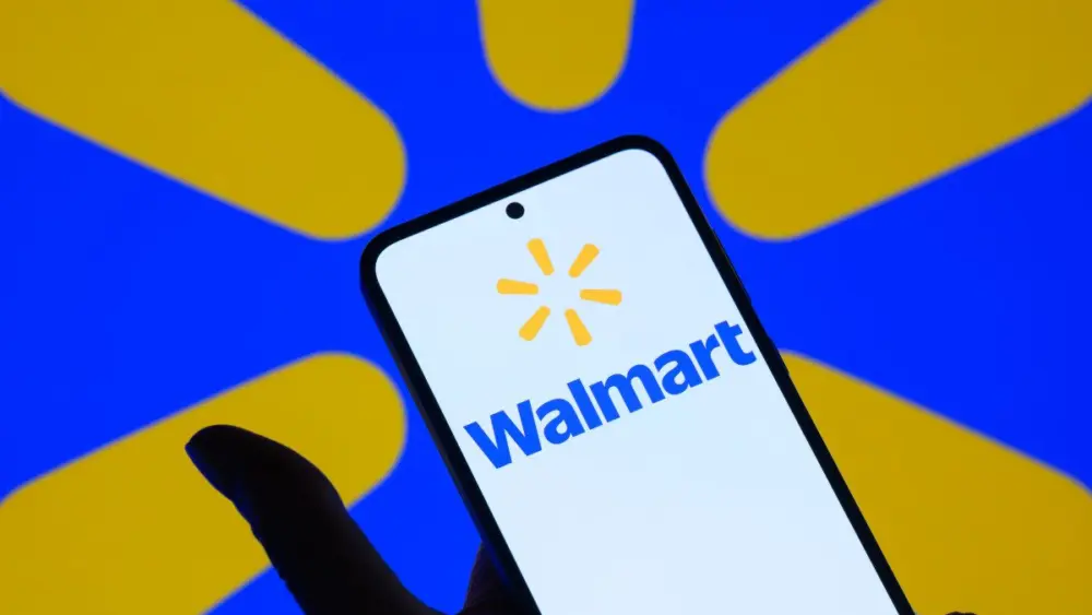 the-walmart-ink-logo-is-displayed-on-a-mobile-phone-with-the-brand-emblem-seen-in-the-background-in-this-photo-illustration-in-brussels-belgium-on-august-18-2025-photo-by-jonathan-raanurphoto-via-ge-3