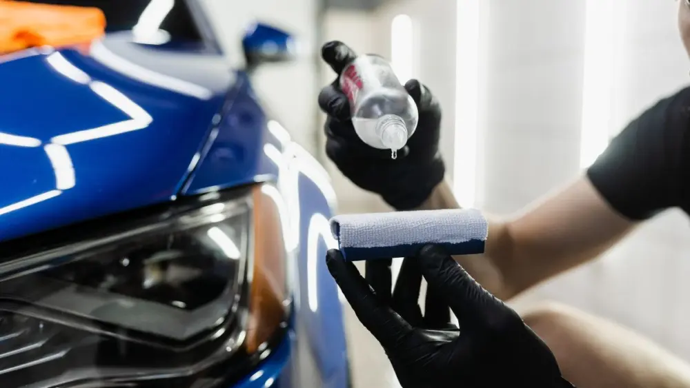 process-of-pouring-ceramic-liquid-from-bottle-on-sponge-to-apply-a-protective-nano-layer-on-car-detailing-service-worker-applies-ceramic-protective-liquid-on-sponge-close-up495432