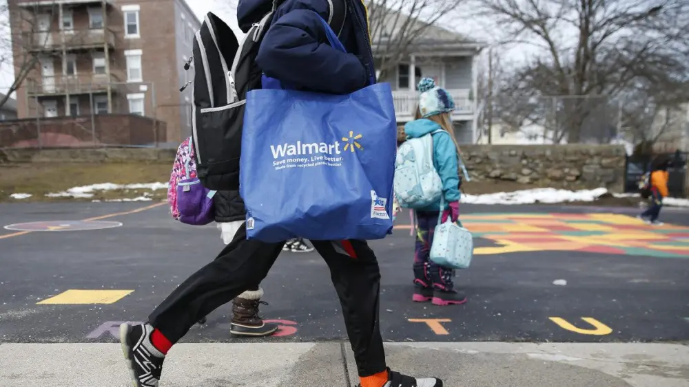 salem-february-23-an-elementary-school-student-with-a-walmart-bag-dashes-away-from-saltonstall-school-after-being-dismissed-for-the-day-in-salem-ma-on-feb-23-2021-governor-charlie-baker-and-state-educ