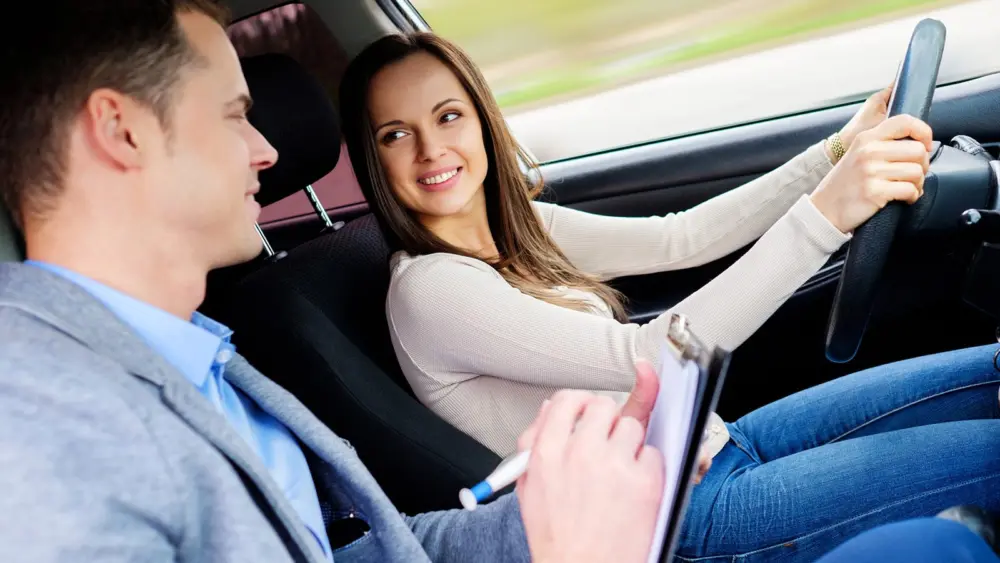 driving-instructor-and-woman-student-in-examination-car