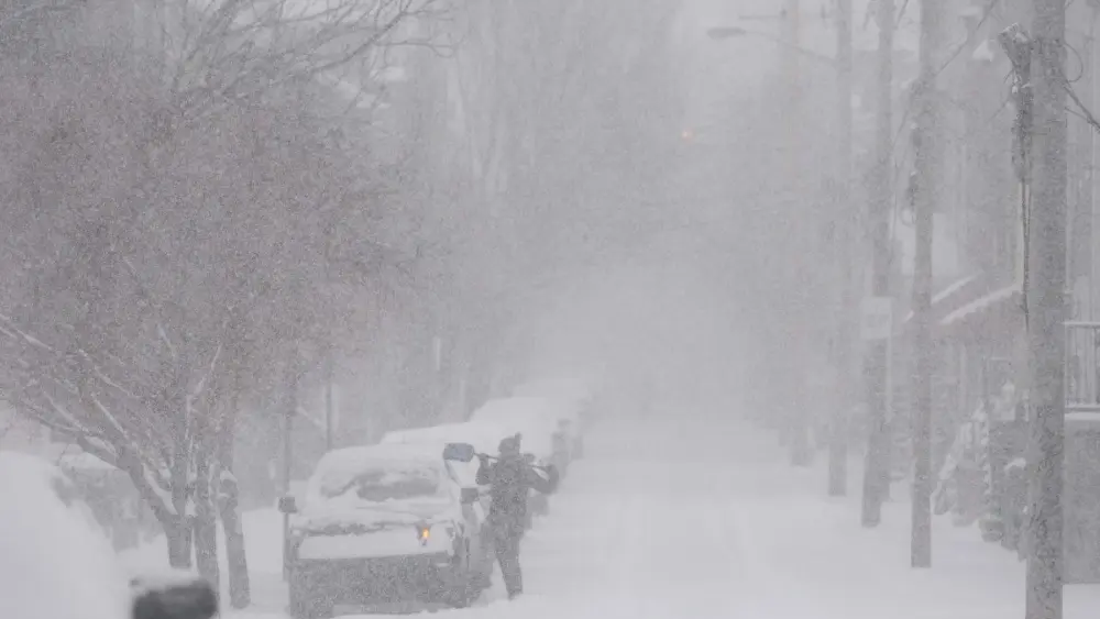 a-person-cleans-snow-off-a-vehicle-during-a-winter-storm-in-pittsburgh-pennsylvania-us-on-sunday-jan-25-2026-a-colossal-winter-storm-reached-the-us-east-coast-sunday-morning-after-dropping-ice-and-sno