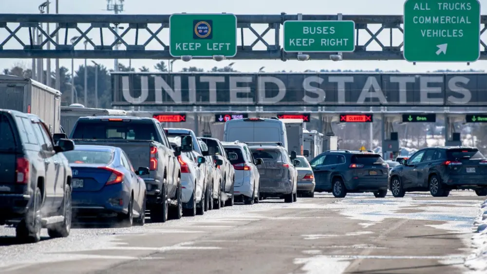 vehicles-in-line-to-cross-into-the-united-states-at-the-canada-us-border-in-st-bernard-de-lacolle-quebec-canada783650