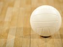 a-lone-white-volleyball-sitting-on-a-wooden-floor