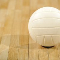 a-lone-white-volleyball-sitting-on-a-wooden-floor