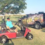 Exploring Energy Radio Show Host Shawn Wilson sits in his golf cart at the 2021 KECO/Moran Equipment Open