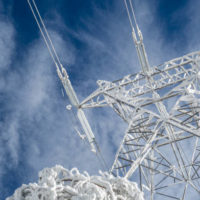 high-voltage-electric-tower-on-a-snowy-day-in-the-mountains