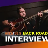 Jake Bush playing his guitar during the Backroads interview