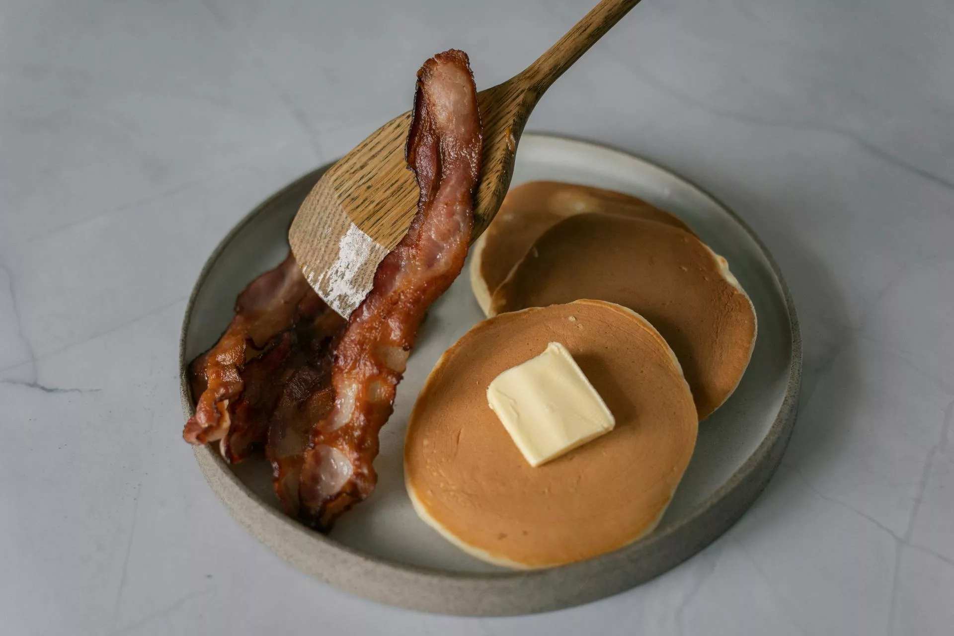 Plate of Pancakes with Butter and Bacon