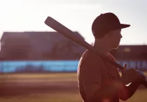 High School Baseball Player Holding Bat
