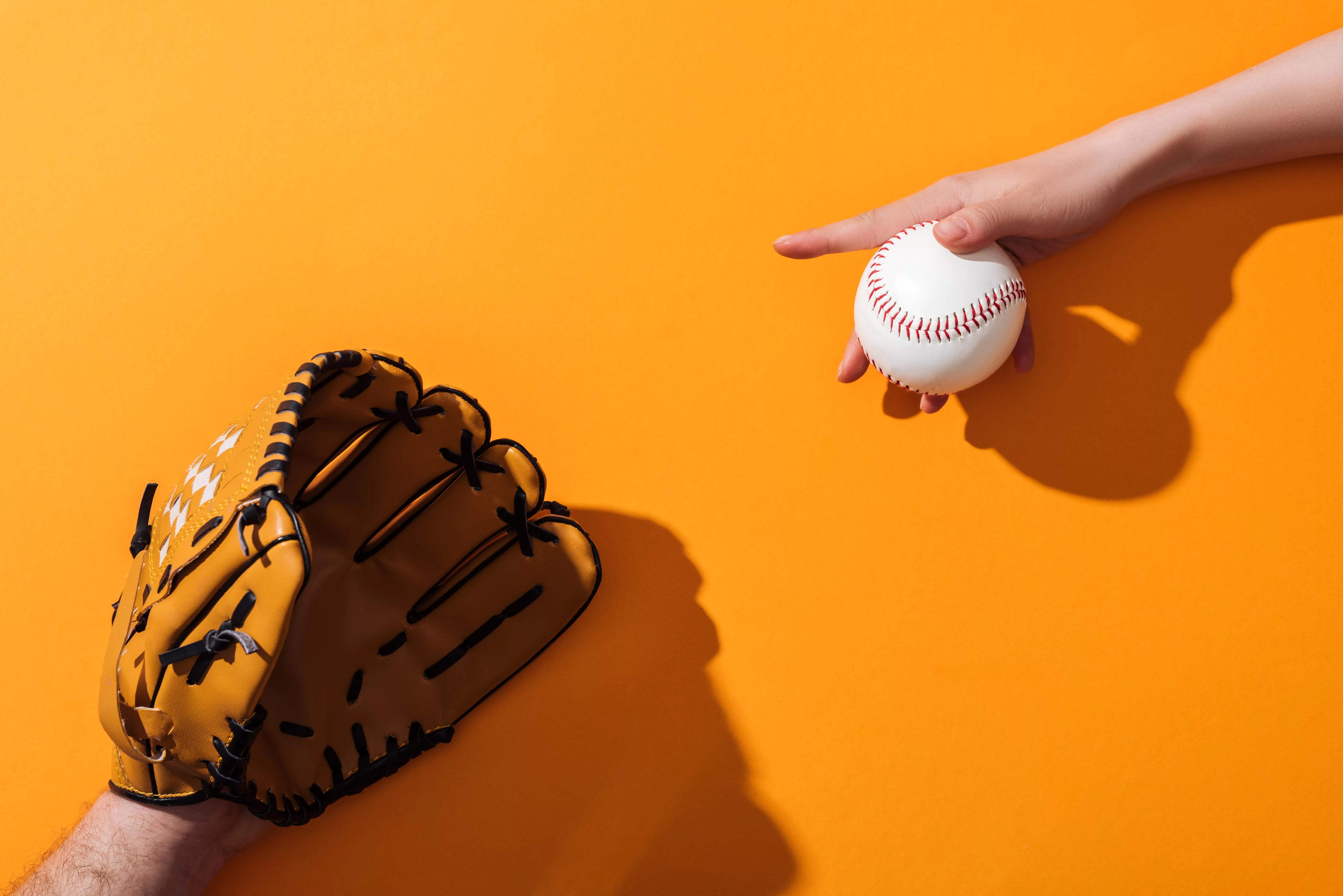 cropped-view-of-man-in-brown-baseball-glove-near