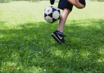 Boy kicking soccer ball