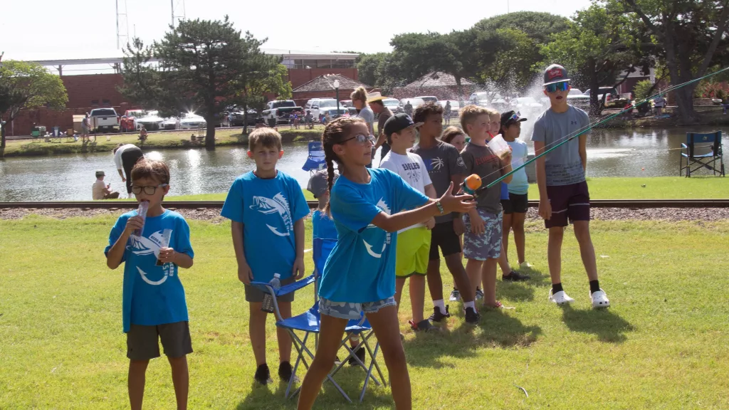 Kids participating in the 2023 Fishing Derby casting contest at Ackley Park.