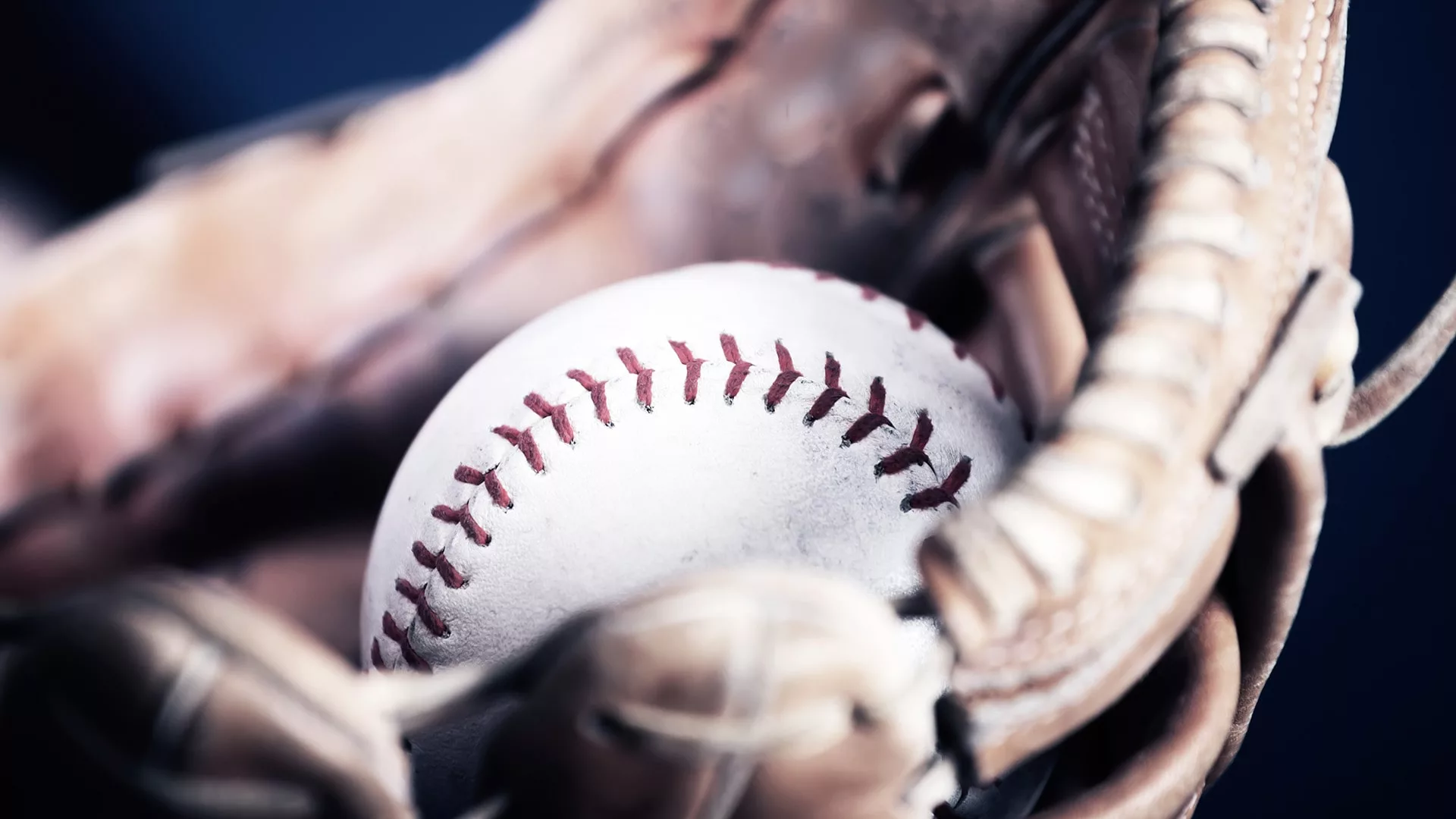 Close-up of a baseball in a glove