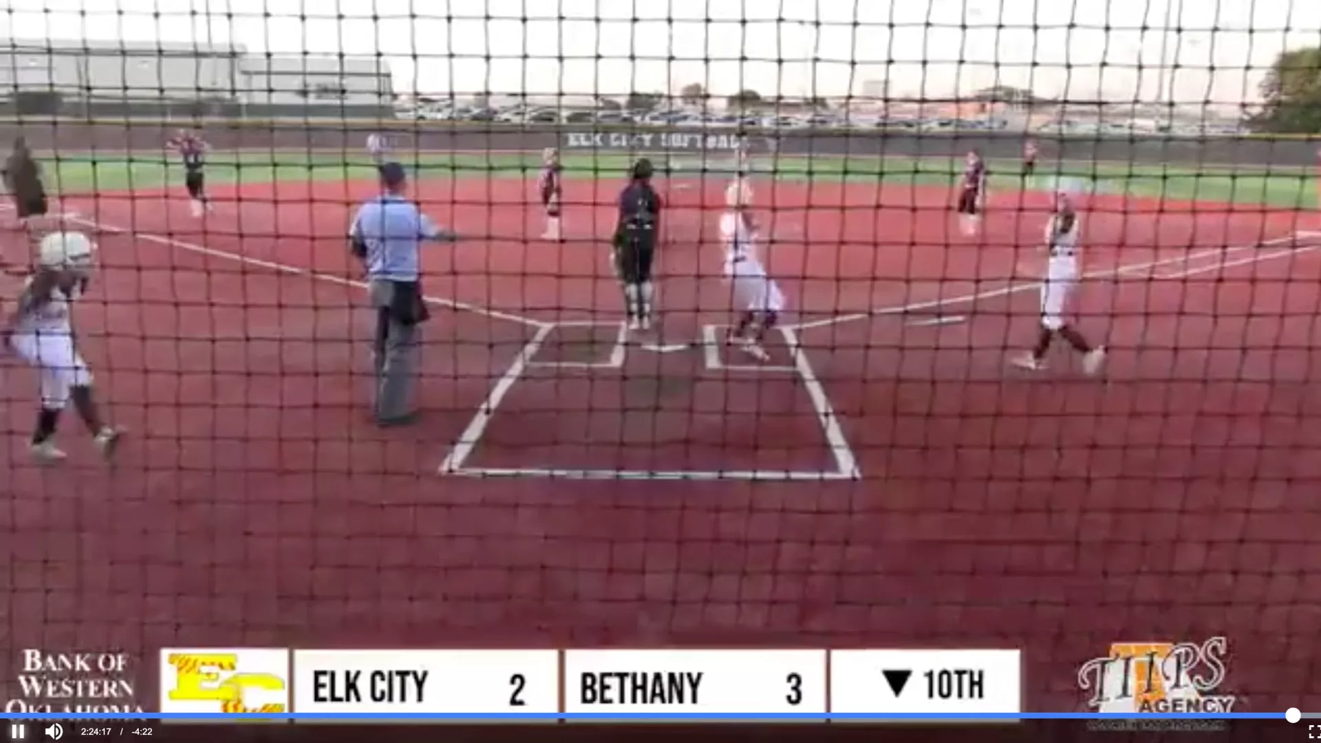 Elk City softball player rounding home plate as the team scores two runs against Bethany in the 10th inning.