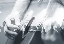 Guitarist with the audience in a double exposure.