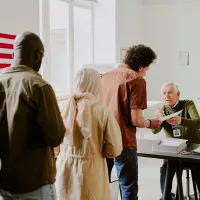 diverse-people-standing-in-line-at-voting-station