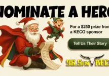 Santa and an elf wearing capes with a “Nominate a Hero” headline, $250 prize note, and the 96.5FM KECO logo.