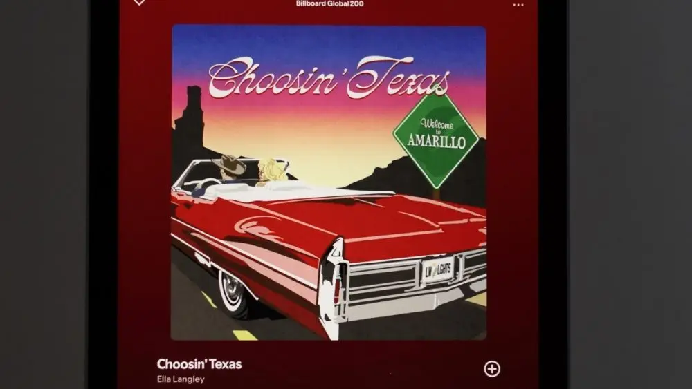 Apple iPad displays the Spotify music streaming application^ which is playing the song "Choosin' Texas" by the artist Ella Langley.