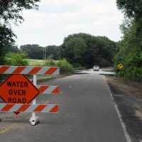 flooding-water-over-road-sign