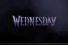 TV on black wall. TV screen playing Netflix series 'Wednesday' trailer