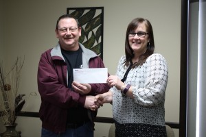 on behalf of Eddie G’s, co-owner Eddie Gerstenberger presents UHS Director Shelli Greschaw with a donation of $2,000 that will be used to financially assist patients with their hospice care.