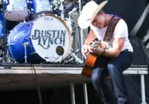 Dustin Lynch performs during the 'Kick The Dust Up' Tour at Vanderbilt Stadium on July 11^ 2015 in Nashville^ Tennessee.