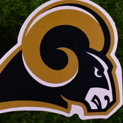 The logo of the Los Angeles Rams football club on the green lawn of the stadium.