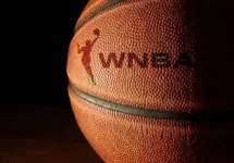 Closeup of a basketball with the WNBA logo and text