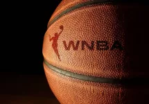 Closeup of a basketball with the WNBA logo and text