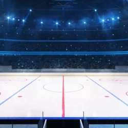 Grand ice hockey rink and illuminated indoor arena with fans^ tribune side view^ professional hockey sport 3D render illustration background
