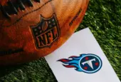 Tennessee Titans NFL team Logo and American football ball on Green Grass. TENNESSEE^ USA^ FEBRUARY 10^ 2025