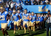 UCLA players run onto the field before an NCAA college football game between the UCLA and the Arizona State^ Nov. 11^ 2023^ in Pasadena^ Calif.