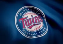 Close-up of waving flag with Minnesota Twins MLB baseball team logo^ seamless loop. Editorial footage