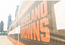 Cleveland Brown's Banner Closeup Leading To The Structural Cityscape Skyline Of Downtown Cleveland. Cleveland^ Ohio/USA - June 1^ 2019