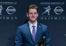 Quarterback Joe Burrow of the LSU Tigers winner of the 85th annual Heisman Memorial Trophy poses with trophy at the Marriott Marquis Hotel New York^ NY - December 14^ 2019