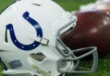Indianapolis Colts helmet shown on field next to football; Colts host the Oakland Raiders on 9/29/19 at Lucas Oil Stadium in Indianapolis IN-USA