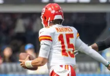 KC Chiefs quarterback Patrick Mahomes #15 runs to escape a tackle by LA Chargers outside linebacker Bud Dupree #48 during an NFL football game at SoFi Stadium^ Aug. 17^ 2024^ in Inglewood^ Calif.