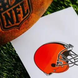 Cleveland Browns NFL team Logo and American football ball on Green Grass. CLEVELAND^ USA^ FEBRUARY 10^ 2025