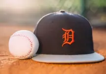 MLB Baseball ball with Detroit Tigers cap on pitchers mound.