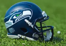 NFL Seattle Seahawks replica helmet on artificial grass playing turf ^ product shot