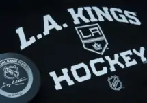 Official NHL game puck with LA kings equipment ^ product shot