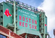 Vew of the historic architecture of the Famous Fenway Park Stadium in Boston^ MA^ USA showcasing its huge sign^ old brick walls^ and entrances on Lansdowne street. Boston^ MA^ USA - March 1^ 2023