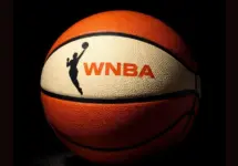 AI Generated photo featuring basketball with the WNBA logo^ background is completely black with ball illuminated artistically. (This content was generated by an Artificial Intelligence (AI) system.)
