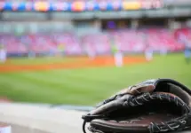 Baseball glove on the wall with a major league stadium in the background